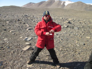 Walter Andriuzzi takes a soil sample in the McMurdo Dry Valleys in January 2016. He steps on rocks to avoid disturbing the ground
